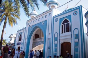 The iconic entrance and minarets of the Shah Jalal Dargah Sharif in Sylhet, a major pilgrimage site in Bangladesh.
